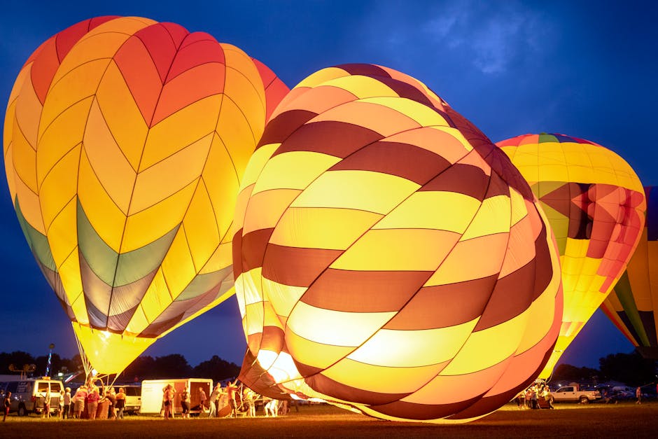 Group of people preparing bright air balloons to fly